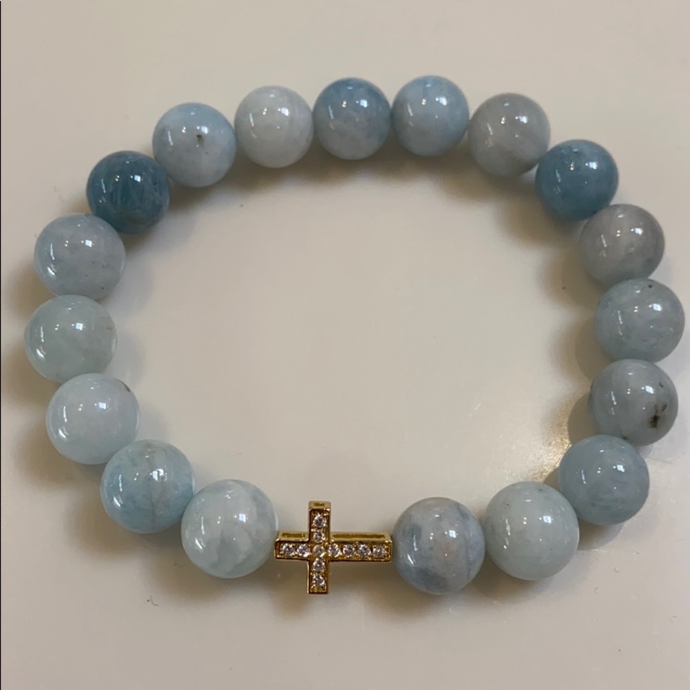 Aquamarine stone with gold plated cross